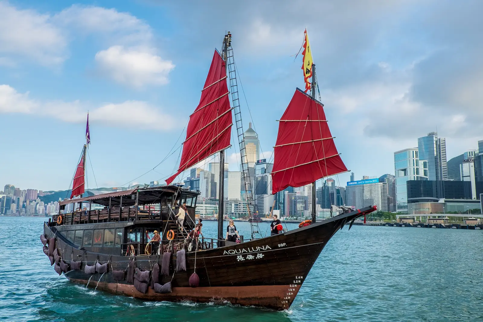 A red-sailed junk boat on Victoria Harbour, Hong Kong
