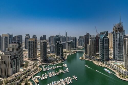 pexels-photo-29470821-29470821 Stunning aerial view of Dubai Marina's skyline and waterway under a clear blue sky.